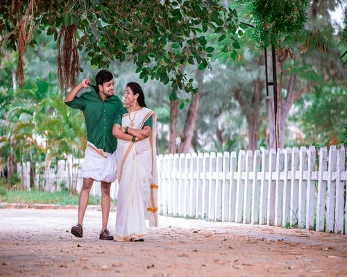 Happy senior indian couple walking in a green park